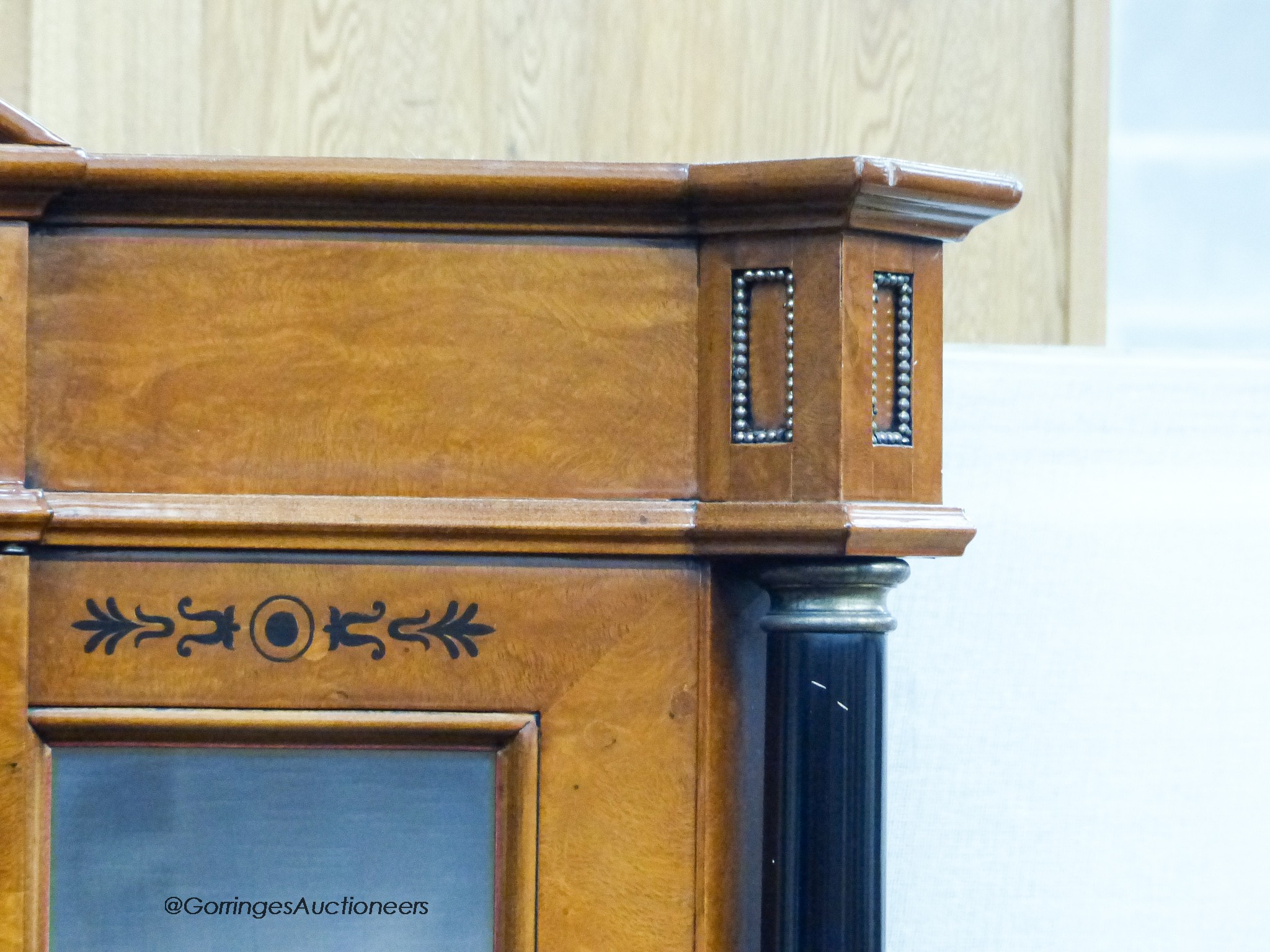 A Biedermeier style ebony inlaid mahogany breakfront display cabinet, W.120cm D.47cm H.197cm